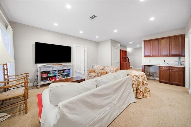 carpeted living room featuring indoor wet bar