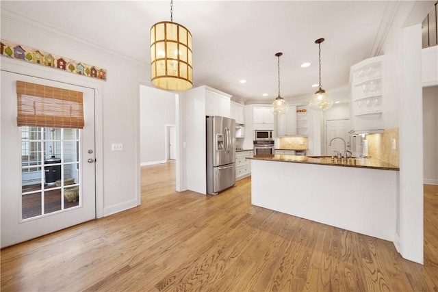 kitchen featuring stainless steel appliances, white cabinetry, hanging light fixtures, and kitchen peninsula