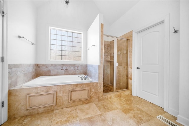 bathroom featuring lofted ceiling and shower with separate bathtub