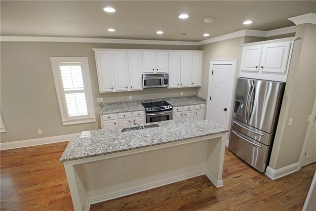 2904 Lone Eagle Ln, Opelika, AL 36801 - kitchen with stainless steel appliances, crown molding, white cabinetry, a sink, and light stone counters