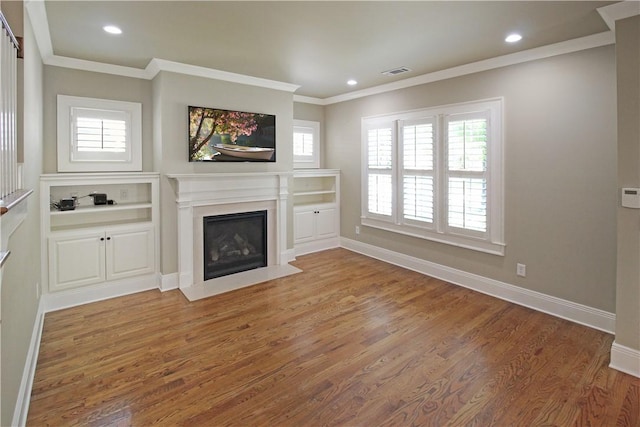 2904 Lone Eagle Ln, Opelika, AL 36801 - unfurnished living room featuring a fireplace with flush hearth, ornamental molding, light wood-style floors, baseboards, and recessed lighting