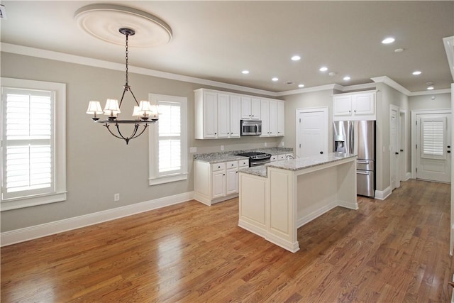 2904 Lone Eagle Ln, Opelika, AL 36801 - kitchen featuring appliances with stainless steel finishes, crown molding, a chandelier, white cabinets, and recessed lighting