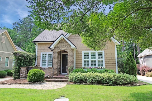 2904 Lone Eagle Ln, Opelika, AL 36801 - view of front of house featuring a front lawn, roof with shingles, and brick siding