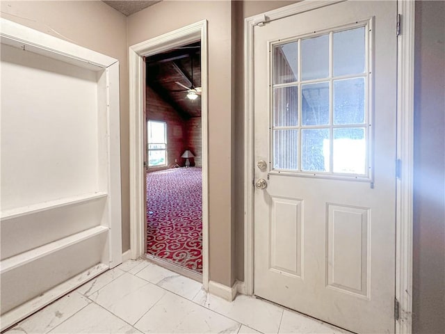 doorway with ceiling fan and plenty of natural light