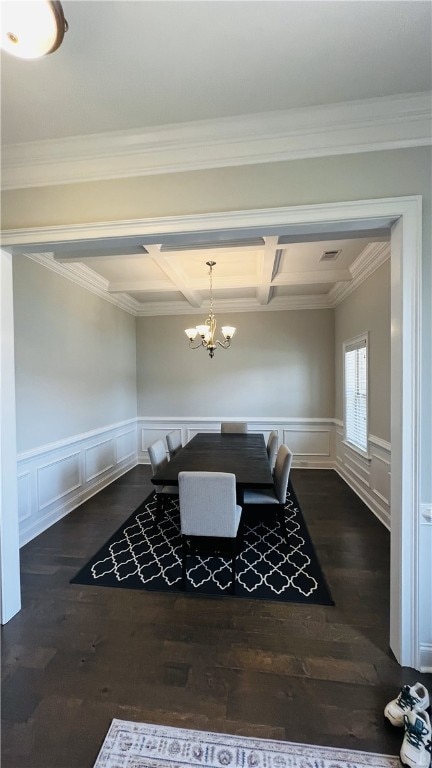 dining area with ornamental molding, coffered ceiling, dark wood-type flooring, beam ceiling, and a chandelier