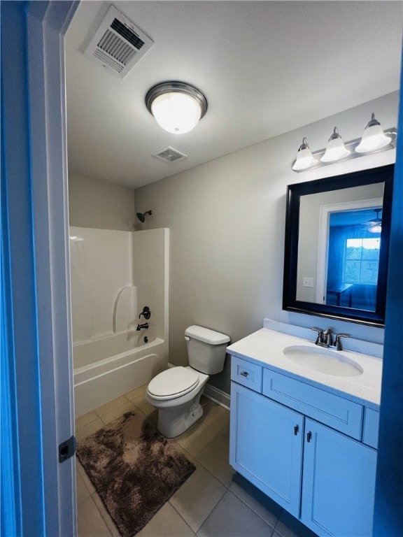 full bathroom featuring toilet, tile patterned floors, vanity, and bathing tub / shower combination