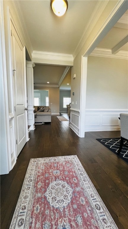 corridor with dark hardwood / wood-style floors and ornamental molding