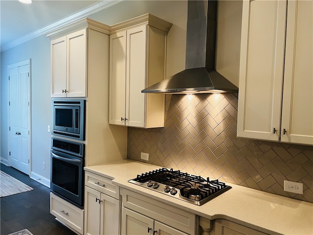 kitchen with tasteful backsplash, crown molding, wall chimney exhaust hood, and stainless steel appliances