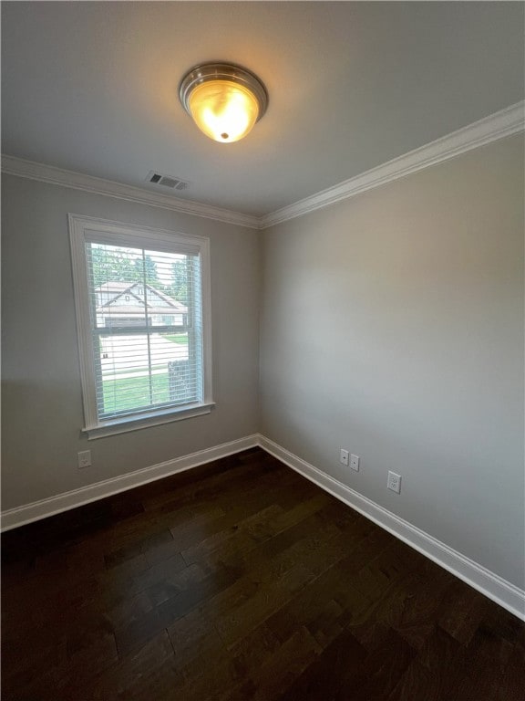 unfurnished room with ornamental molding and dark wood-type flooring