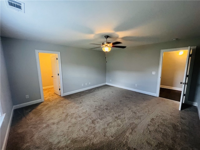 carpeted empty room featuring ceiling fan