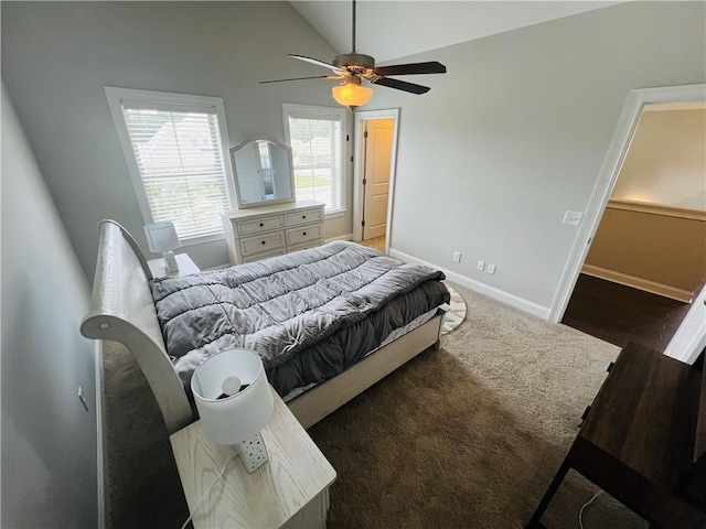 bedroom with vaulted ceiling, ceiling fan, and dark wood-type flooring