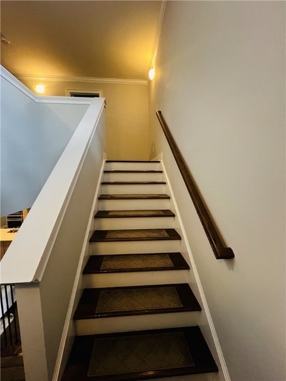 staircase featuring ornamental molding