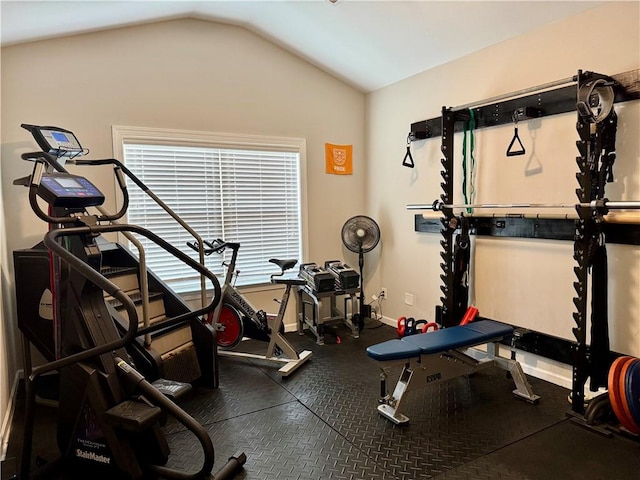 workout area with baseboards, vaulted ceiling, and plenty of natural light