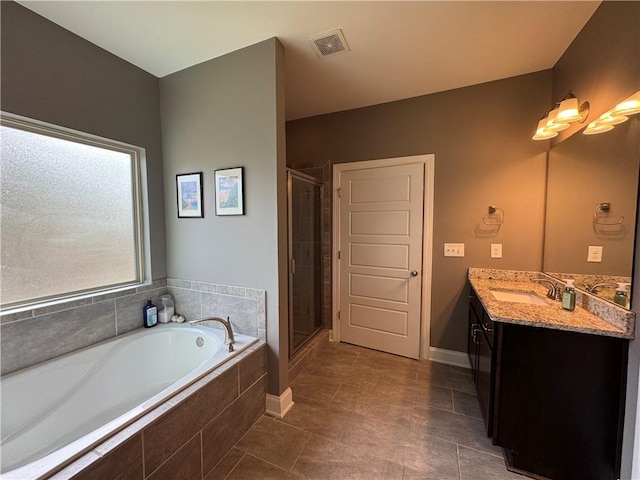 bathroom featuring visible vents, a shower stall, vanity, a garden tub, and tile patterned flooring
