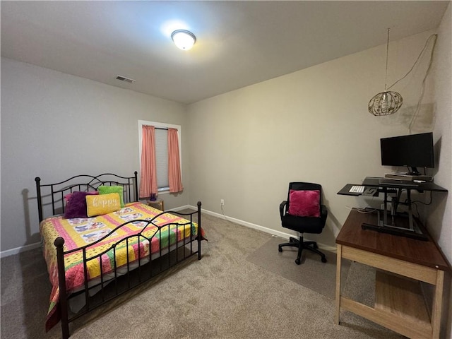 carpeted bedroom with baseboards and visible vents