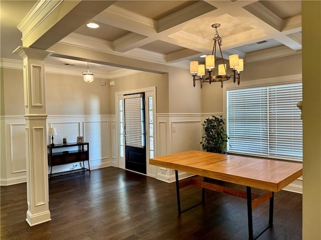 dining room with decorative columns, dark wood-style floors, and beam ceiling