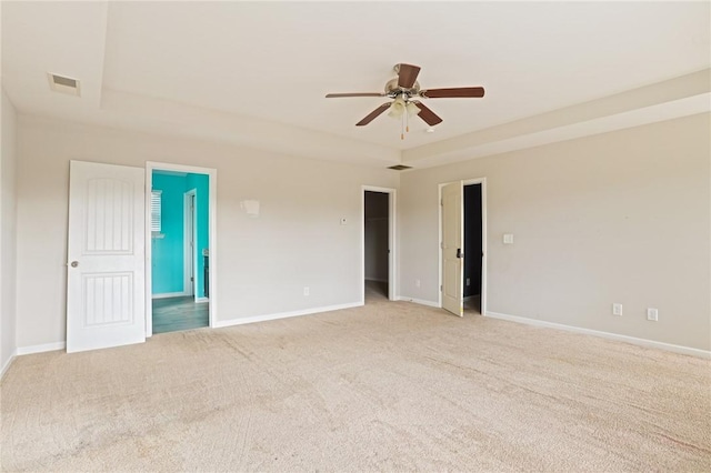 unfurnished room featuring baseboards, visible vents, and light colored carpet