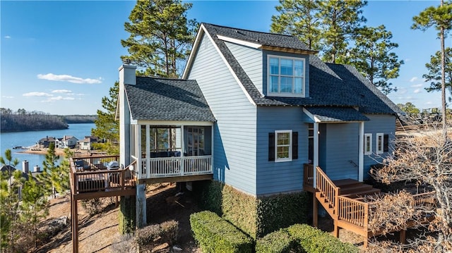 rear view of house featuring a water view