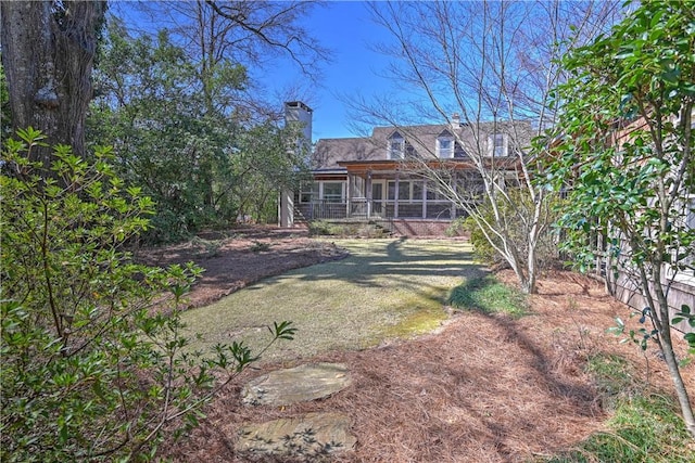 view of yard featuring a sunroom