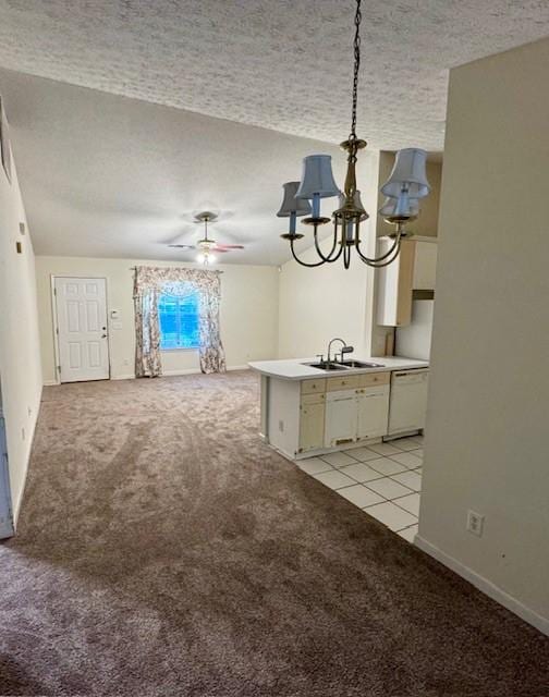 interior space featuring ceiling fan with notable chandelier, light carpet, a textured ceiling, and sink