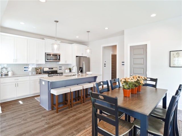 dining room featuring light wood-style flooring and recessed lighting