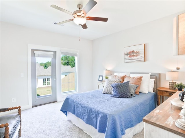 carpeted bedroom with visible vents, access to exterior, and a ceiling fan