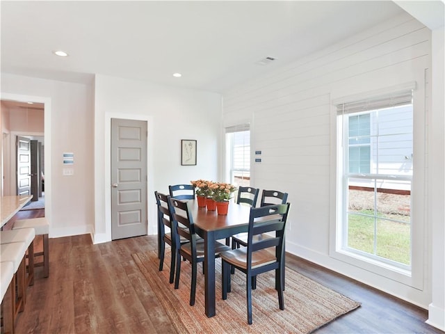 dining space with dark wood-type flooring, recessed lighting, and baseboards