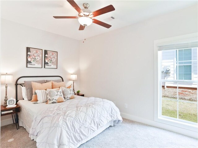 bedroom with carpet flooring, ceiling fan, visible vents, and baseboards