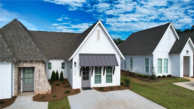 modern inspired farmhouse with a standing seam roof, board and batten siding, roof with shingles, and metal roof