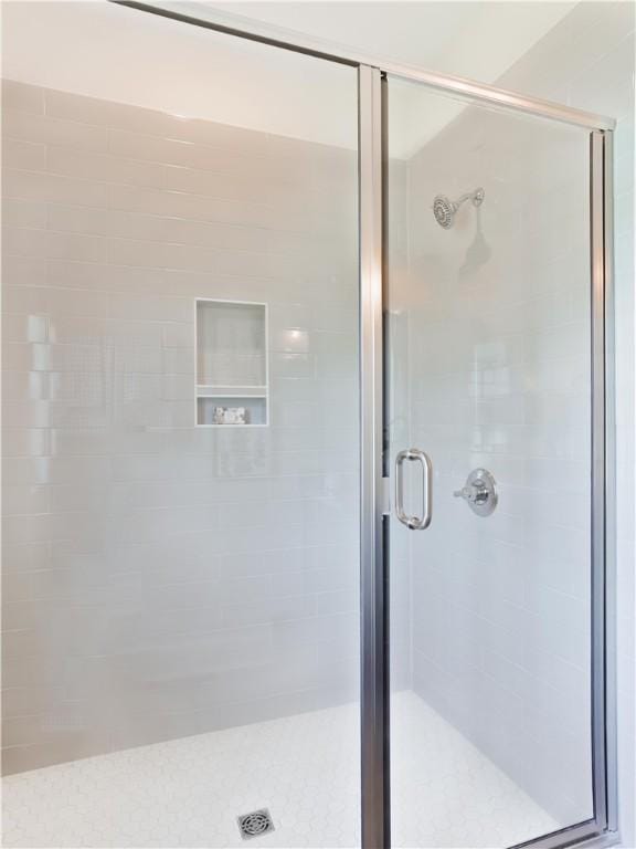 full bath featuring a shower stall