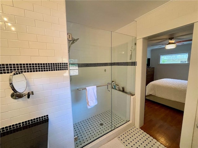 bathroom featuring crown molding, a stall shower, connected bathroom, ceiling fan, and wood finished floors