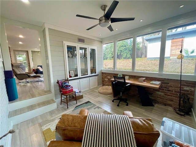 office space with visible vents and a ceiling fan