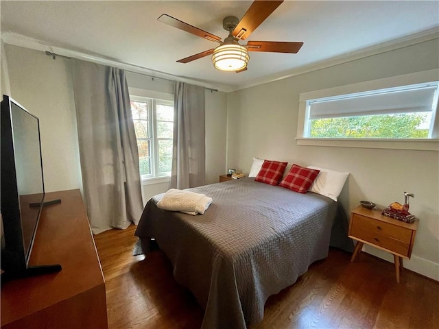 bedroom with ceiling fan and wood finished floors