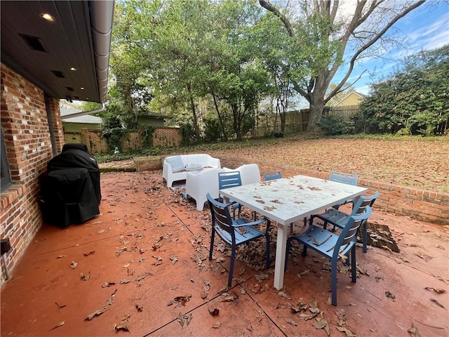 view of patio / terrace featuring outdoor dining area, fence, and grilling area