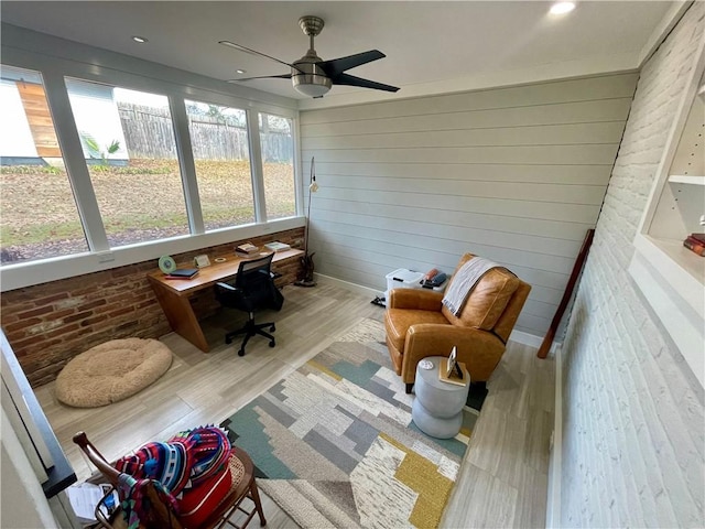 sunroom / solarium featuring ceiling fan