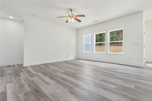 empty room with light wood-type flooring and ceiling fan