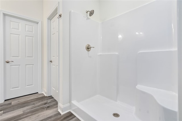 bathroom featuring hardwood / wood-style flooring and a shower