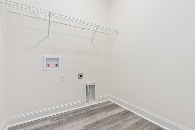 laundry room featuring hookup for a washing machine, hardwood / wood-style flooring, and electric dryer hookup