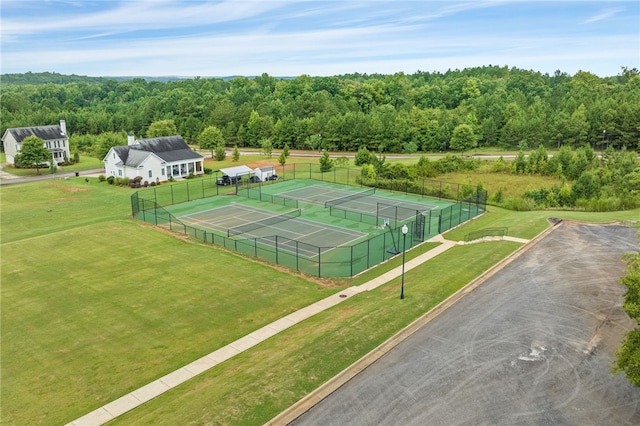 view of sport court featuring a lawn