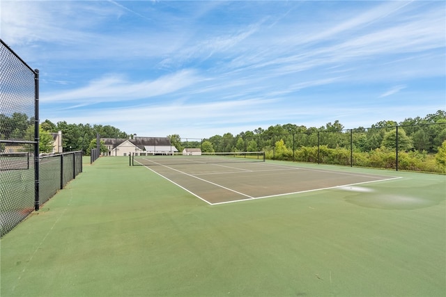 view of tennis court with basketball hoop