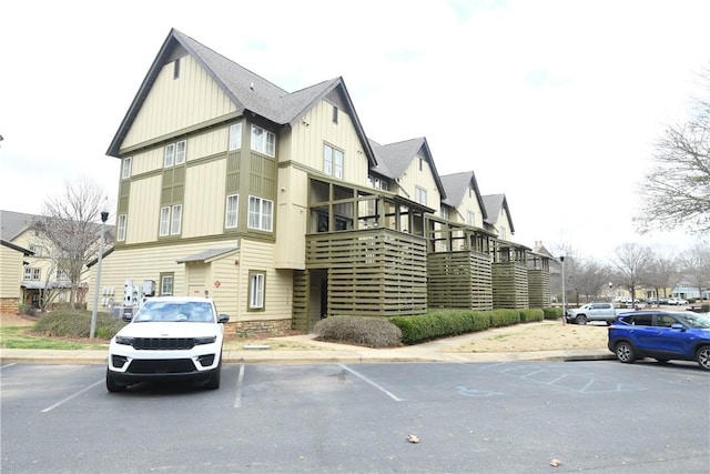 view of building exterior with uncovered parking