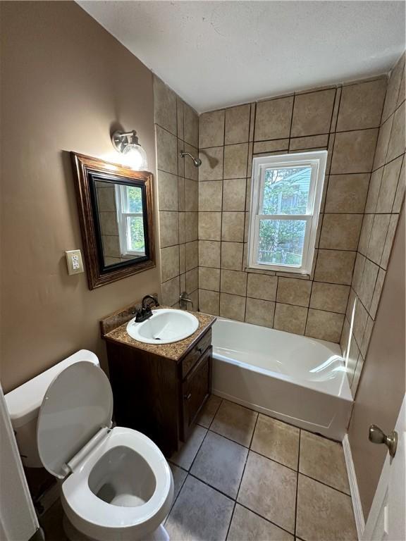 full bathroom with tile patterned floors, vanity, toilet, and tiled shower / bath