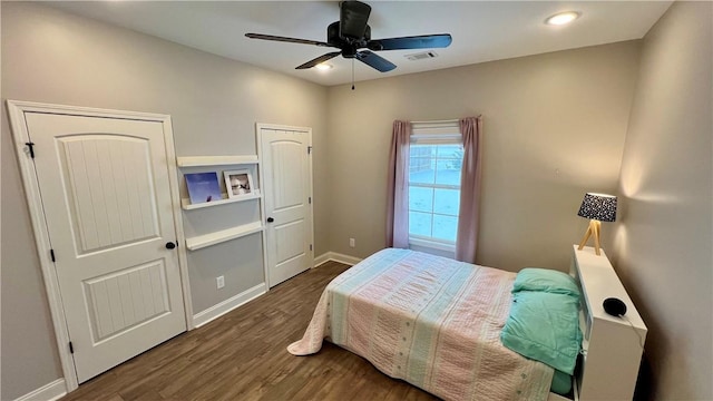 bedroom featuring ceiling fan and dark hardwood / wood-style floors