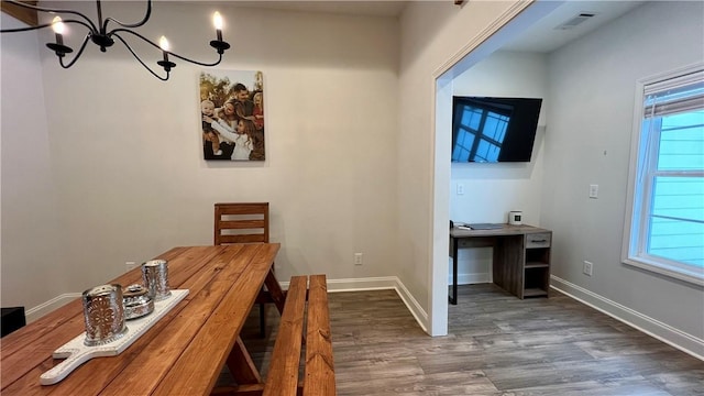 unfurnished office featuring dark hardwood / wood-style floors and a chandelier