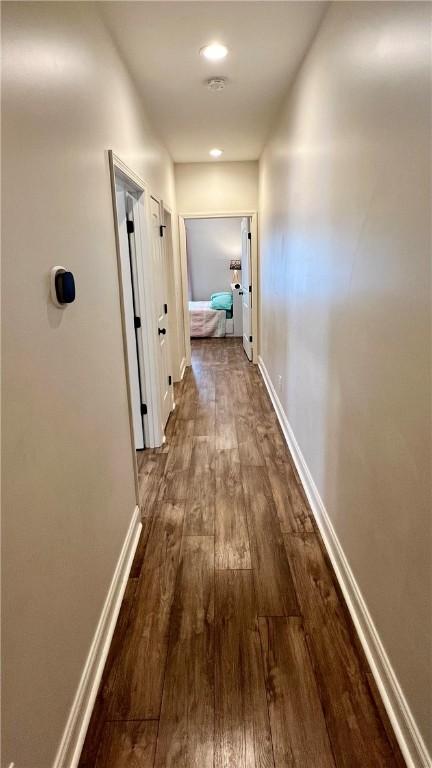 corridor featuring dark wood-type flooring