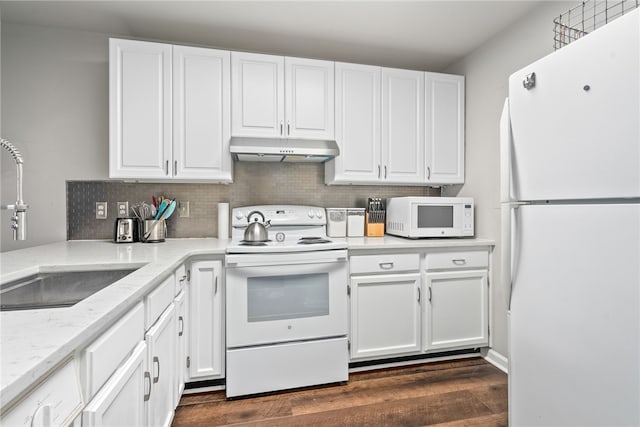 kitchen with light stone countertops, sink, dark wood-type flooring, white appliances, and white cabinets