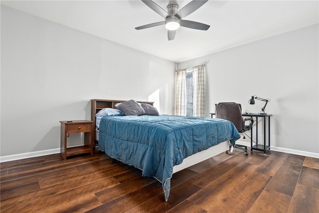 bedroom with dark hardwood / wood-style flooring and ceiling fan