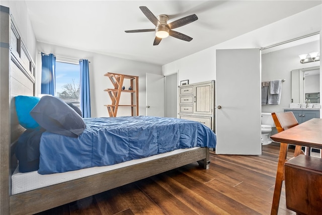 bedroom featuring ceiling fan, sink, ensuite bathroom, and dark hardwood / wood-style floors