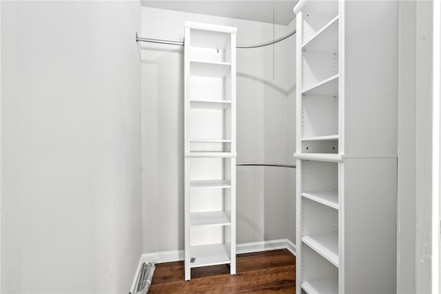 walk in closet featuring dark hardwood / wood-style floors