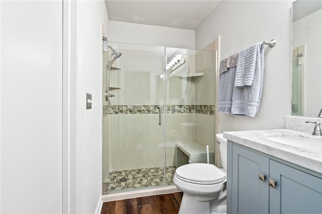 bathroom featuring walk in shower, vanity, and toilet